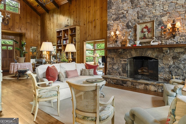 295 Goble Gap Rd, Clayton, GA 30525 - living area featuring high vaulted ceiling, a wood ceiling with exposed beams, wood finished floors, wood walls, and a stone fireplace