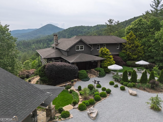 295 Goble Gap Rd, Clayton, GA 30525 - view of front of home with a chimney, a mountain view, a forest view, a patio, and outdoor dining area