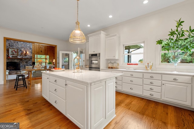 295 Goble Gap Rd, Clayton, GA 30525 - kitchen with a center island, light wood-type flooring, white cabinets, decorative light fixtures, and recessed lighting