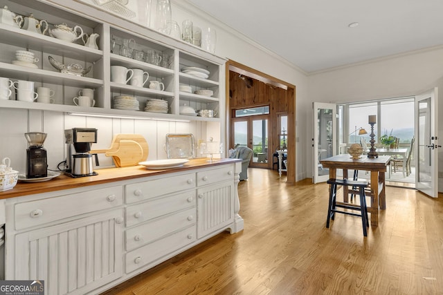295 Goble Gap Rd, Clayton, GA 30525 - kitchen featuring ornamental molding, open shelves, white cabinetry, light wood finished floors, and butcher block counters