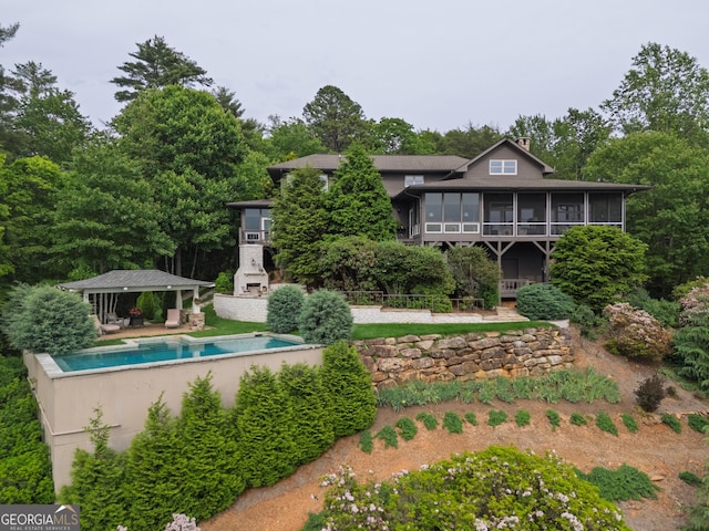 295 Goble Gap Rd, Clayton, GA 30525 - rear view of house with a sunroom, an outdoor pool, and a patio area