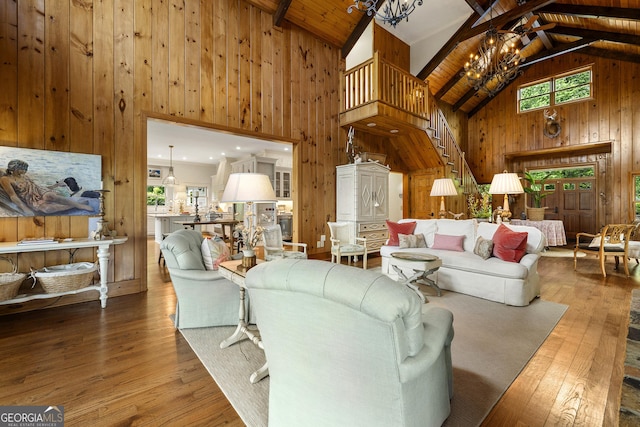 295 Goble Gap Rd, Clayton, GA 30525 - living room featuring wood walls, a chandelier, high vaulted ceiling, wood-type flooring, and stairway