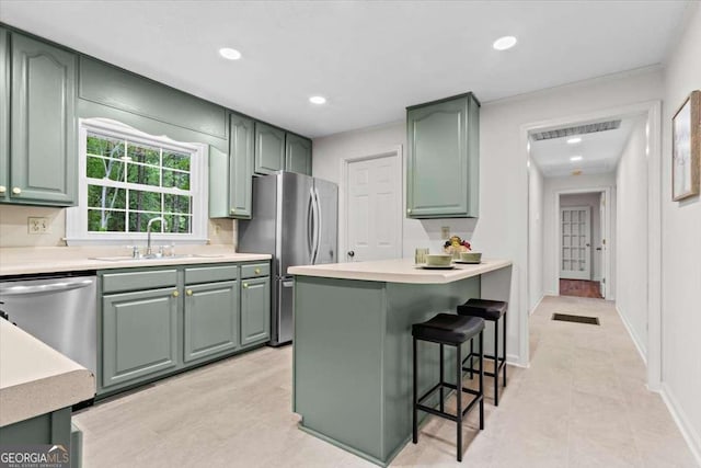 5766 Macland Rd, Powder Springs, GA 30127 - kitchen featuring stainless steel appliances, green cabinetry, a breakfast bar area, and recessed lighting