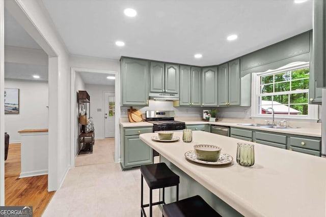 5766 Macland Rd, Powder Springs, GA 30127 - kitchen featuring green cabinets, stainless steel appliances, under cabinet range hood, recessed lighting, and light countertops