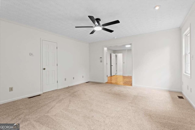 5766 Macland Rd, Powder Springs, GA 30127 - empty room with light colored carpet, a ceiling fan, crown molding, and a textured ceiling