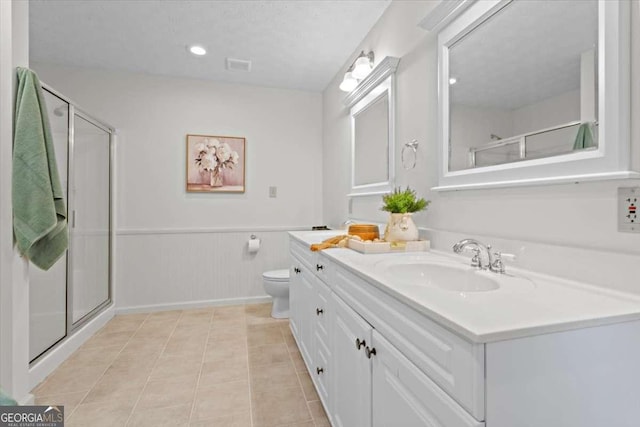 5766 Macland Rd, Powder Springs, GA 30127 - bathroom featuring vanity, a stall shower, wainscoting, and tile patterned floors