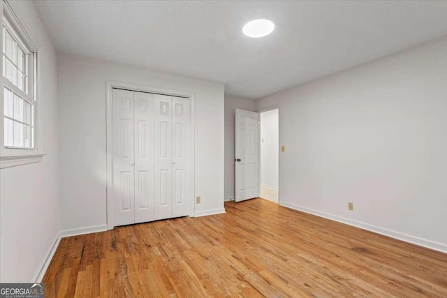 5766 Macland Rd, Powder Springs, GA 30127 - unfurnished bedroom with light wood-type flooring and a closet