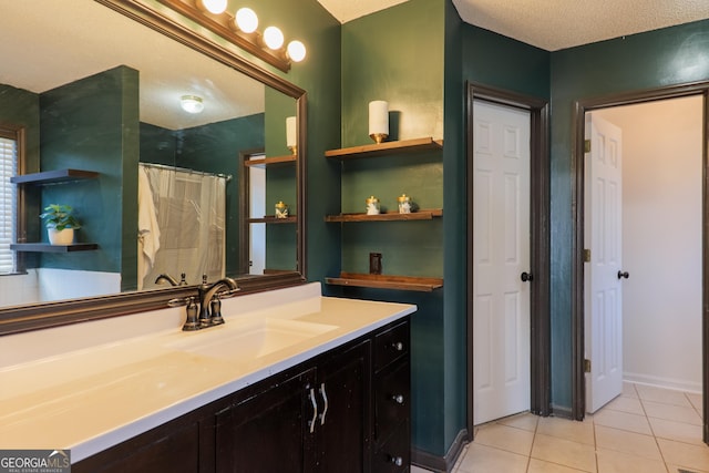 bathroom with baseboards, curtained shower, tile patterned flooring, and vanity