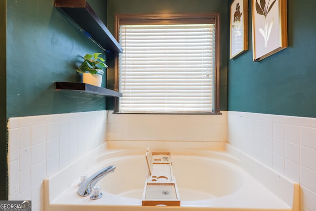 bathroom with a healthy amount of sunlight and a bath