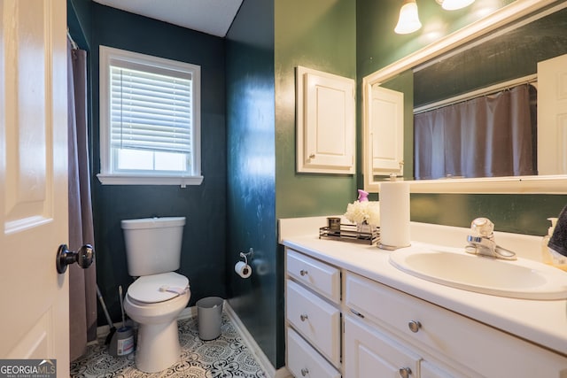 bathroom featuring toilet, tile patterned flooring, vanity, and baseboards