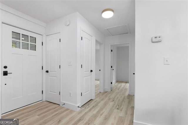 entrance foyer featuring light wood-type flooring and baseboards