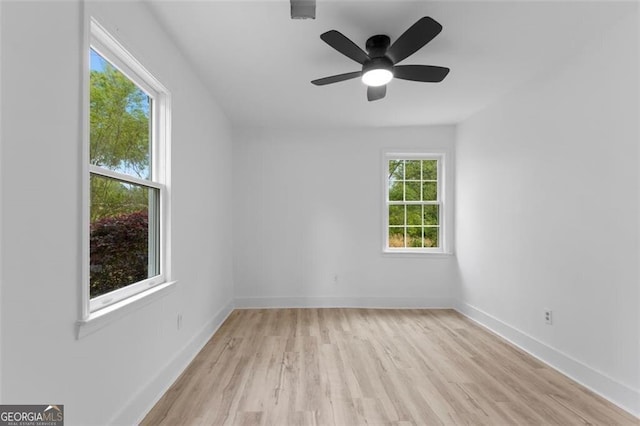 unfurnished room featuring ceiling fan, baseboards, and light wood-style floors
