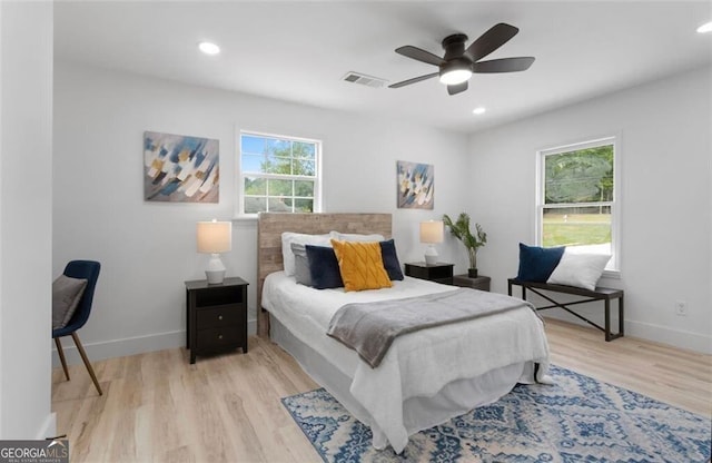 bedroom featuring baseboards, light wood-style floors, visible vents, and recessed lighting