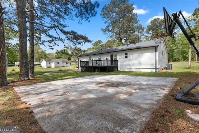 back of house with a lawn, a wooden deck, and cooling unit