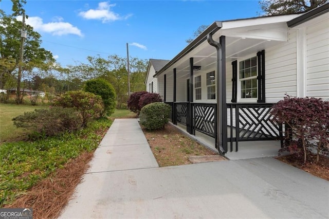 view of side of property with covered porch