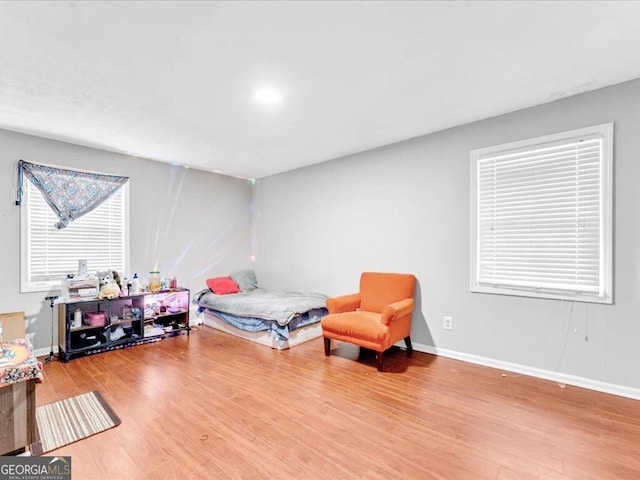 bedroom featuring wood finished floors and baseboards