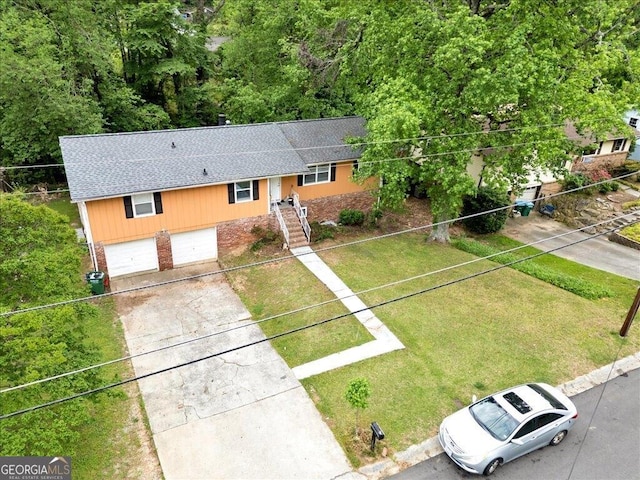 view of front facade featuring a front yard, driveway, brick siding, roof with shingles, and an attached garage