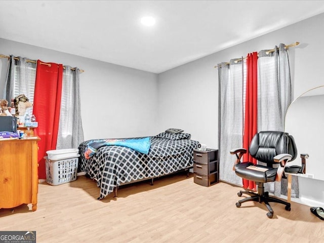 bedroom with recessed lighting and wood finished floors