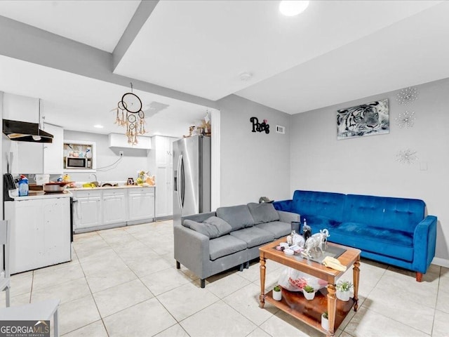 living area featuring visible vents and light tile patterned floors