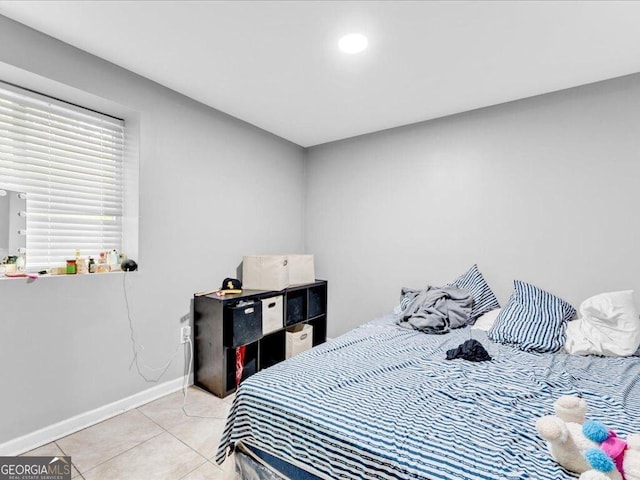 bedroom featuring light tile patterned floors and baseboards
