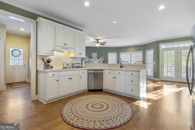 kitchen featuring dishwasher, ceiling fan, a peninsula, and wood finished floors