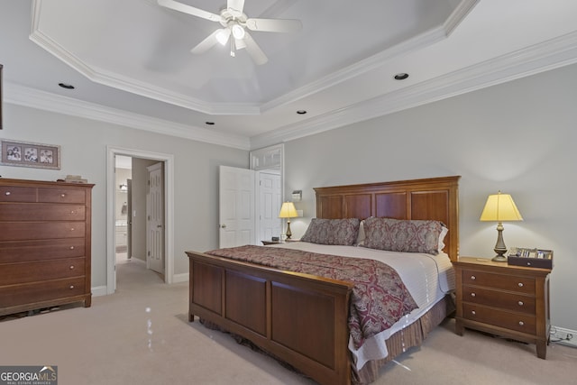 bedroom featuring ornamental molding, baseboards, a tray ceiling, and light colored carpet