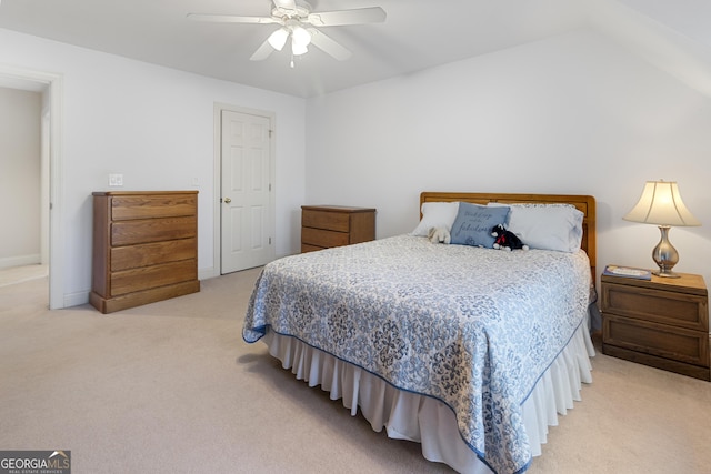 bedroom with a ceiling fan and light colored carpet