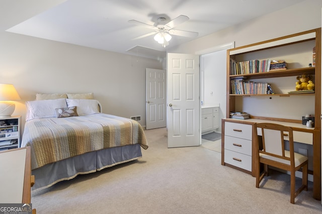 bedroom with attic access, light carpet, ensuite bath, and visible vents