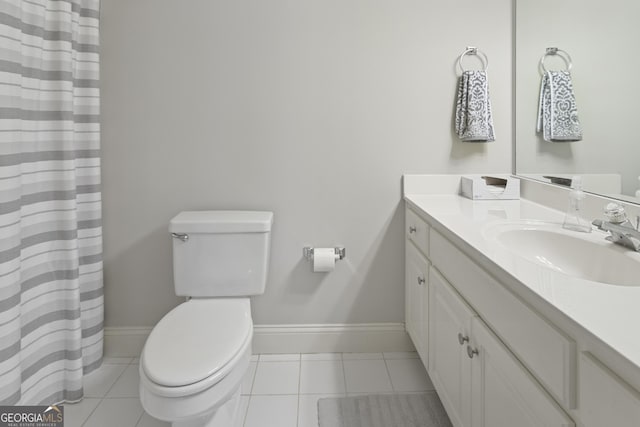 bathroom featuring tile patterned flooring, baseboards, toilet, and vanity