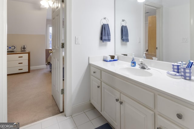 bathroom with baseboards, vanity, and tile patterned flooring
