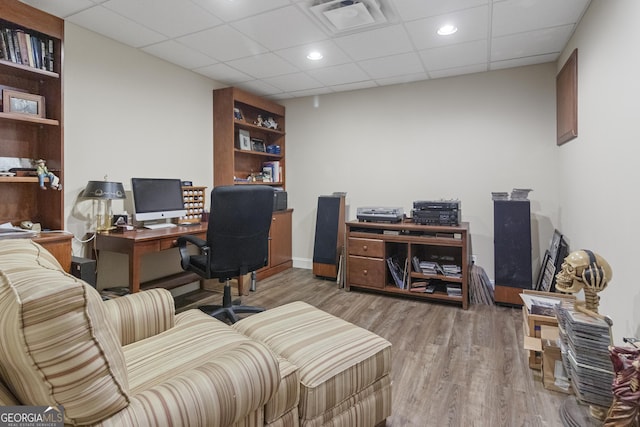 office space with a drop ceiling, wood finished floors, visible vents, and recessed lighting