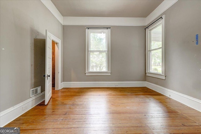 19 Mcdonough St, Hampton, GA 30228 - spare room with baseboards, visible vents, a healthy amount of sunlight, and light wood-style flooring
