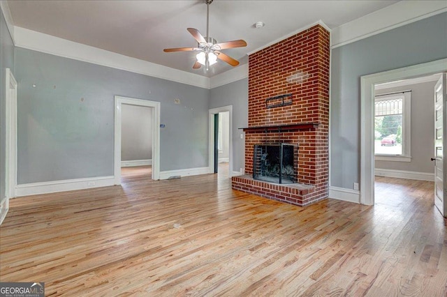 19 Mcdonough St, Hampton, GA 30228 - unfurnished living room with baseboards, wood finished floors, a ceiling fan, and a fireplace