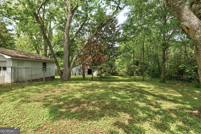 19 Mcdonough St, Hampton, GA 30228 - view of yard with fence and a detached garage