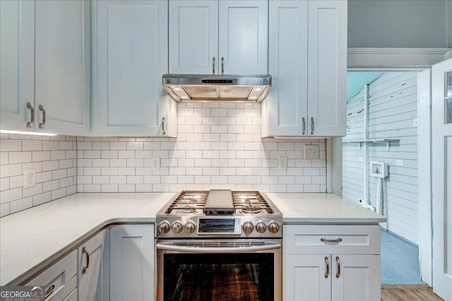 19 Mcdonough St, Hampton, GA 30228 - kitchen featuring tasteful backsplash, stainless steel gas range oven, under cabinet range hood, and light countertops