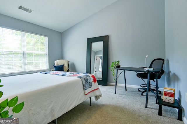 carpeted bedroom with lofted ceiling, visible vents, and baseboards