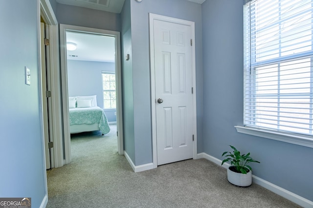 unfurnished bedroom with carpet floors, visible vents, and baseboards