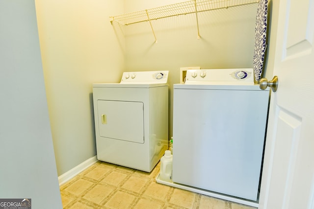 laundry area with light floors, washing machine and dryer, baseboards, and laundry area