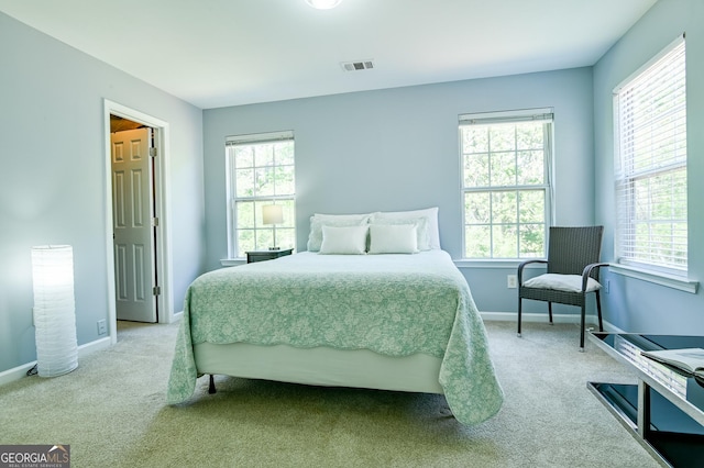 carpeted bedroom with baseboards and visible vents