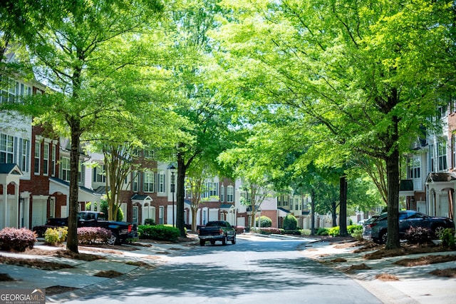 view of road featuring a residential view, curbs, and sidewalks