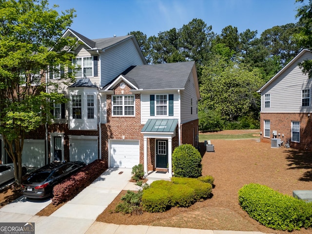 view of front of home featuring brick siding, an attached garage, a shingled roof, and concrete driveway