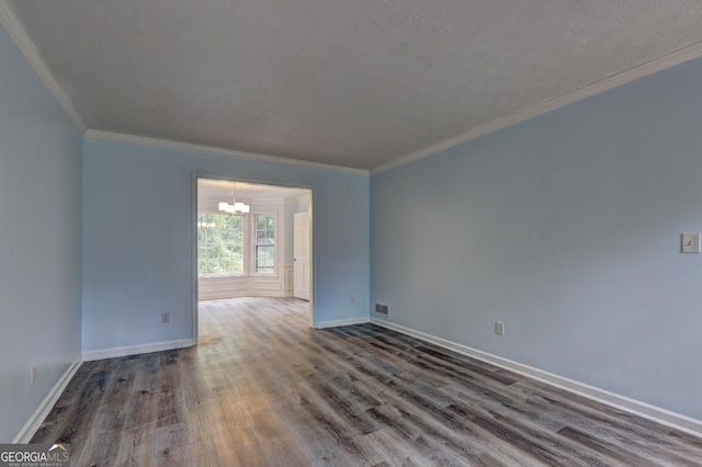 5621 Wildwood Trl, Lithonia, GA 30038 - spare room featuring wood finished floors, baseboards, ornamental molding, and an inviting chandelier
