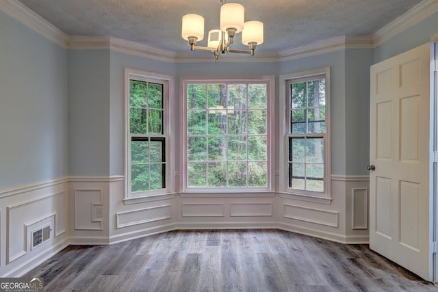 5621 Wildwood Trl, Lithonia, GA 30038 - unfurnished dining area with wainscoting, plenty of natural light, wood finished floors, and a chandelier
