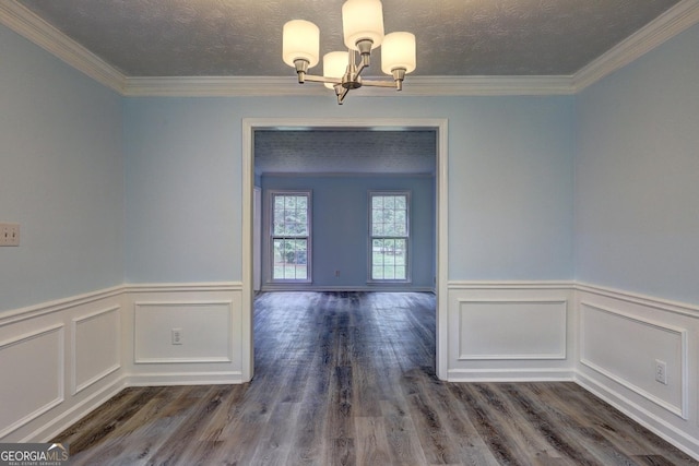 5621 Wildwood Trl, Lithonia, GA 30038 - unfurnished dining area featuring ornamental molding, a notable chandelier, a wainscoted wall, and wood finished floors
