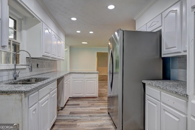 5621 Wildwood Trl, Lithonia, GA 30038 - kitchen with a sink, light wood-style floors, appliances with stainless steel finishes, white cabinetry, and recessed lighting