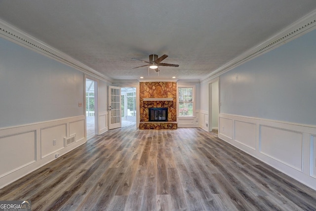 5621 Wildwood Trl, Lithonia, GA 30038 - unfurnished living room featuring a decorative wall, wainscoting, ceiling fan, ornamental molding, and visible vents