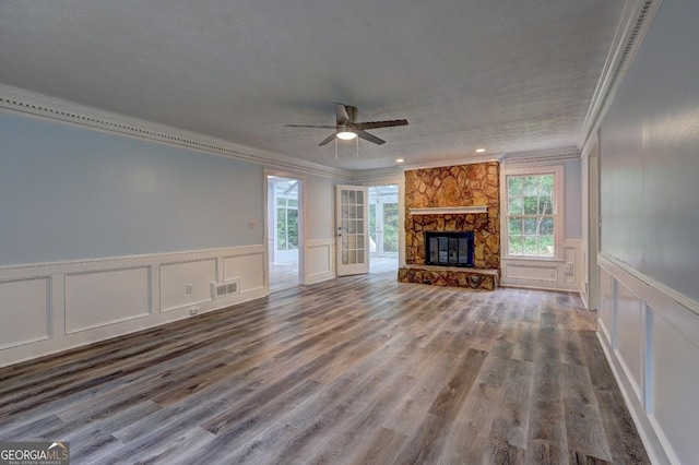 5621 Wildwood Trl, Lithonia, GA 30038 - unfurnished living room featuring ceiling fan, a decorative wall, crown molding, and visible vents