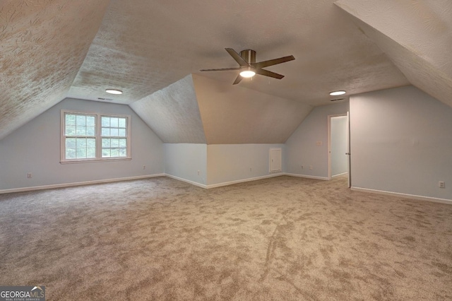 5621 Wildwood Trl, Lithonia, GA 30038 - additional living space featuring lofted ceiling, baseboards, a textured ceiling, and carpet flooring
