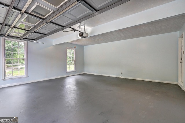 5621 Wildwood Trl, Lithonia, GA 30038 - garage with baseboards and a garage door opener
