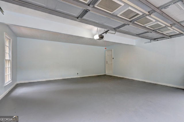 5621 Wildwood Trl, Lithonia, GA 30038 - garage featuring a garage door opener and baseboards